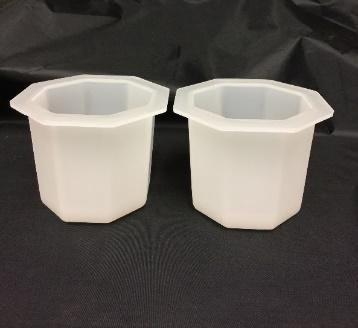 Two hexagonal ice molds for a Spirit Ice Vice ice ball press