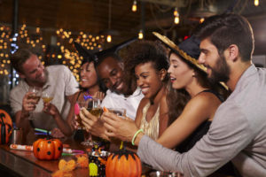 guests celebrating halloween at a bar
